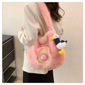 Detail of pink plush crossbody bag with donut embroidery and duck plush pendant charm