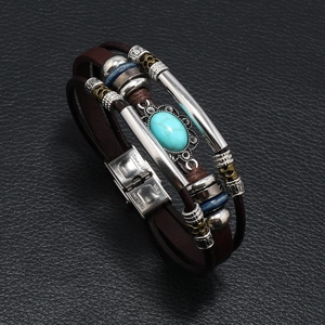 Men's leather braided bracelet with turquoise and stainless steel on black texture