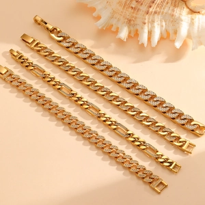 Detailed close-up of gold Cuban and Figaro chains with iced-out pave rhinestones