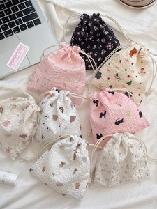Assorted cute cartoon drawstring storage bags in various bear and floral patterns