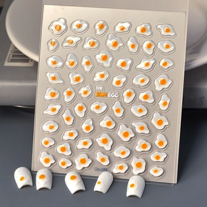 Detail showing 3D fried egg nail stickers with jelly texture on white nail tips