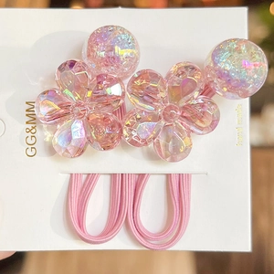 Close-up of pink crystal flower and bead elastic hair ties set on a handmade display card