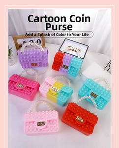 Flat lay of silicone pop-it coin purses with pearl handles and gold twist locks