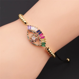 Adjustable evil eye bracelet with colorful zircons and gold beads on a wrist