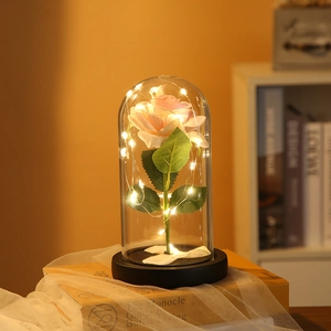 Pink LED rose in clear glass dome with black base for romantic home decor lighting