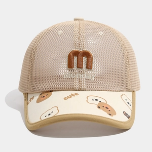 Detail of baby sun hat with mesh crown and cartoon bear patterns on the brim
