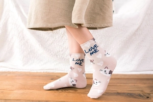 Detail of pink cotton mid-calf socks with cute cartoon cat and LOVE ME knit pattern