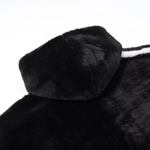 Detailed macro view showing the soft texture of black faux fur plush hooded coat fabric