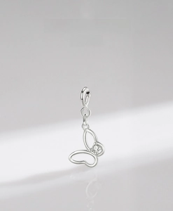 Macro detail of s925 sterling silver hollow butterfly pendant with zircon stone