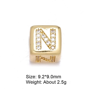 Detailed macro view of 9.2mm gold letter N bead with white zircon stones for jewelry