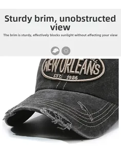 Close-up of distressed brim on a vintage washed cotton baseball cap with embroidery