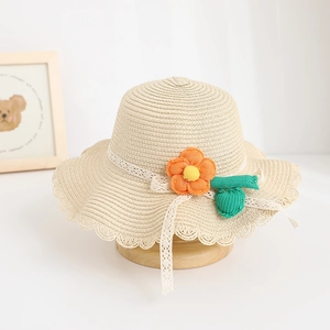 Detail view of children's straw hat featuring a handmade crochet flower and lace ribbon.
