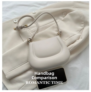 Detailed comparison of a cream leather saddle bag size next to a black smartphone
