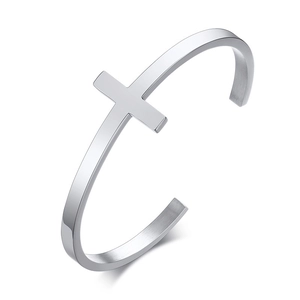 Detail view of silver stainless steel cuff bracelet with minimalist cross motif