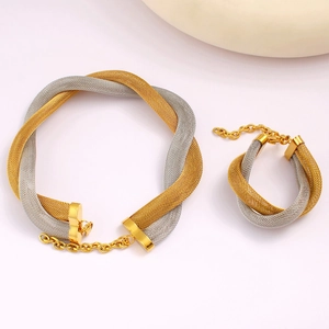 Detailed view of woven mesh necklace and bracelet set in gold and silver stainless steel