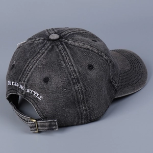 Detail of adjustable metal buckle and NO CAP NO STYLE embroidery on denim baseball cap