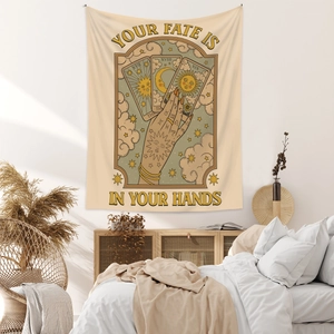 Bohemian tarot tapestry featuring the sun and moon hanging in a cozy bedroom