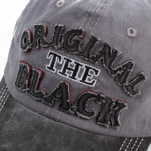 Detail of vintage washed grey baseball cap with embroidered ORIGINAL THE BLACK text