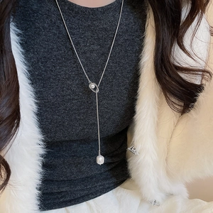 Silver Y-shaped adjustable necklace featuring a baroque pearl pendant on a long delicate chain