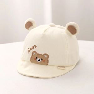 Close-up of soft cotton baby cap with bear embroidery and cute 3D plush ears