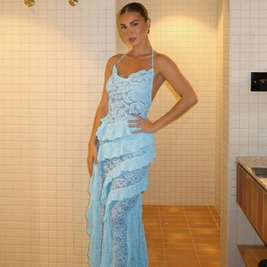 Detail of light blue lace maxi dress featuring layered ruffles and elegant open back