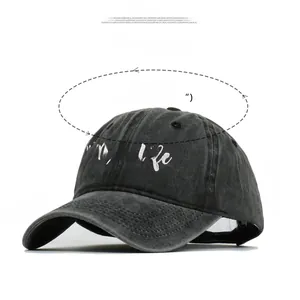 Close-up of #Momlife white embroidery on vintage washed grey cotton baseball cap
