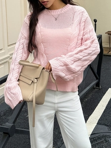 Detailed view of pink cable knit texture on a long sleeve crewneck sweater for women