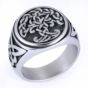 Macro shot of retro stainless steel ring featuring intricate Tree of Life engraving