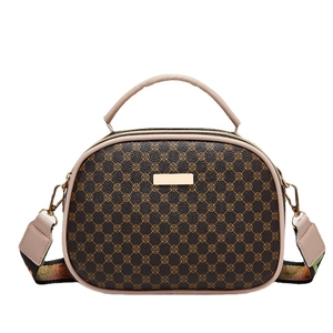 Vintage brown monogram handbag with white handle and striped crossbody strap