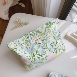 Close-up of floral print cotton makeup bag with Simple Wish label and fabric texture