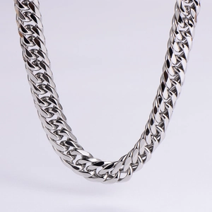 Macro shot of silver polished stainless steel Cuban link chain with dense interlocking rings