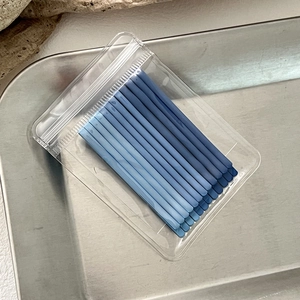 Close-up of blue gradient metal hairpins packaged in a clear zipper bag on a tray