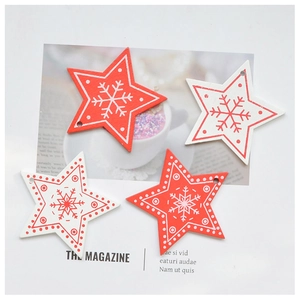 Detail of red and white wooden star ornaments with snowflake patterns for Christmas trees