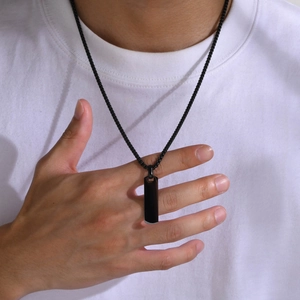 Minimalist black stainless steel tag pendant necklace on model with white t-shirt