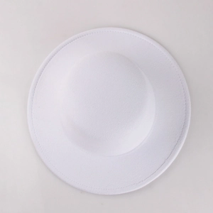 Top-down view of a white wool felt fedora hat showing its smooth texture and wide brim