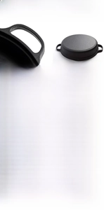 Detailed macro view of the un-coated cast iron pan showing dual handles and thick base