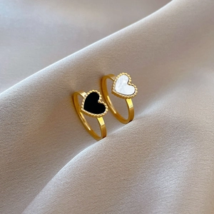 Minimalist heart-shaped rings in black and white mother of pearl with beaded gold edges