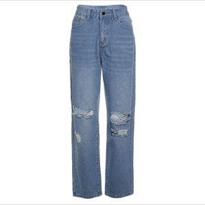 Light blue high waisted denim jeans with distressed knee rips and raw hem on white background