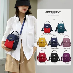 Multi-compartment nylon crossbody bag with adjustable strap in various color options