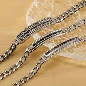 Cuban link bracelets in titanium steel with black and white zircon on golden satin background
