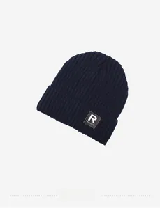 Detailed view of dark blue ribbed knit beanie with R FASHION square fabric patch