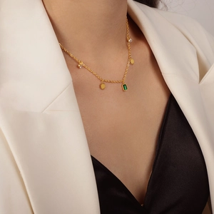 Gold sunburst necklace featuring emerald green pendant and zircon accents for women