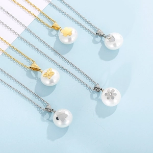 Detailed view of stainless steel necklaces with gold and silver chains and irregular white pearls