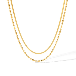 Close-up of golden multi-layer necklace with flat snake chain and beaded link design