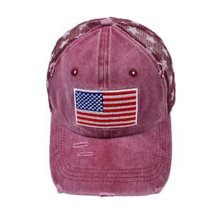 Close-up of embroidered US flag patch and distressed mesh detail on a baseball cap