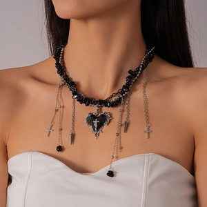 Detail of gothic choker with black gravel beads, silver heart cross and tassel pendants