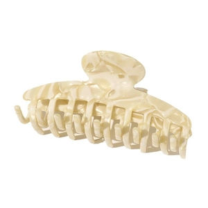 Close-up of cream acetate hair claw clip showing marble texture and minimalist design