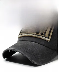 Macro shot of washed cotton baseball cap with embroidered Beach patch and frayed brim