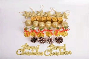 Detailed assortment of gold Christmas ornaments including stars, bells, and pine cones