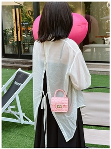 Pink quilted PVC jelly bag featuring a gold chain strap and decorative rope handle detail